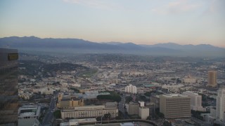 5K stock footage video fly between skyscrapers in Downtown Los Angeles at sunset toward East Los Angeles, California Aerial Stock Footage | DCLA_045