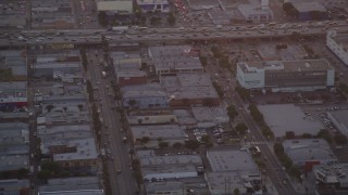 DCLA_057 - 5K aerial stock footage track police helicopter over city streets and buildings in Downtown Los Angeles at twilight, California