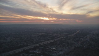 5K aerial stock footage of setting sun over Interstate 10 and suburbs in Mid-City Los Angeles, California Aerial Stock Footage | DCLA_067