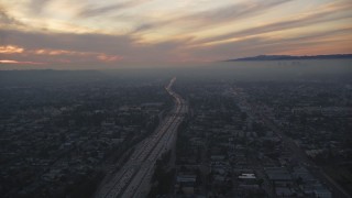 DCLA_068 - 5K aerial stock footage of sunset in the clouds over Interstate 10 through Mid-City Los Angeles, California