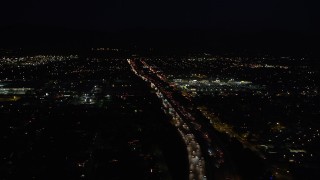 5K aerial stock footage tilt from highway 118 to reveal and approach shopping center at night in Pacoima, California Aerial Stock Footage | DCLA_098