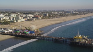 DCLA_125 - 5K stock footage video orbit the Santa Monica Pier with visitors in Los Angeles, California