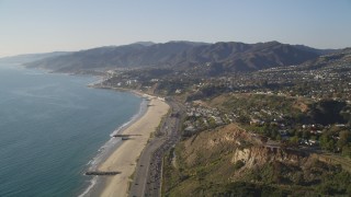 5K aerial stock footage fly over beach and tilt up Highway 1 in Pacific Palisades, California Aerial Stock Footage | DCLA_132