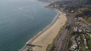 DCLA_133 - 5K aerial stock footage tilt from bird's eye view of Highway 1 and beach by Pacific Palisades, California