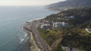 5K aerial stock footage follow Highway 1 to approach condos in Pacific Palisades, California Aerial Stock Footage | DCLA_135