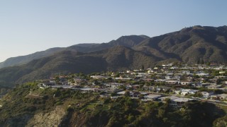 5K aerial stock footage tilt from Highway 1 to reveal neighborhood  on cliff in Malibu, California Aerial Stock Footage | DCLA_138