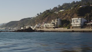 DCLA_143 - 5K aerial stock footage fly low by beachfront homes in Malibu, California