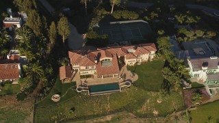 DCLA_150 - 5K aerial stock footage tilt from ocean to reveal and approach beachfront homes and hilltop mansion in Malibu, California