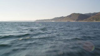 DCLA_158 - 5K aerial stock footage tilt from ocean to reveal and approach coastline in Malibu, California