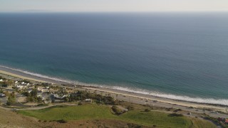 DCLA_163 - 5K aerial stock footage fly over mountain to reveal and approach Highway 1 in Malibu, California