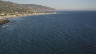 5K aerial stock footage fly over seagulls over the ocean and tilt to reveal Malibu, California Aerial Stock Footage | DCLA_170