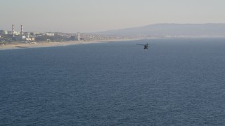 5K aerial stock footage track military helicopter to reveal the coastline in El Segundo, California Aerial Stock Footage | DCLA_188