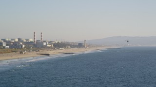 DCLA_189 - 5K aerial stock footage follow helicopter toward beach and oil refinery in El Segundo, California