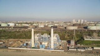 5K aerial stock footage of oil refinery by the beach with smoke stacks in El Segundo, California Aerial Stock Footage | DCLA_192