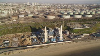 DCLA_197 - 5K aerial stock footage pass building with smoke stacks at oil refinery in El Segundo, California