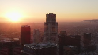 5K aerial stock footage tilt from dark streets to reveal and approach Downtown Los Angeles towers at sunset, California Aerial Stock Footage | DCLA_233