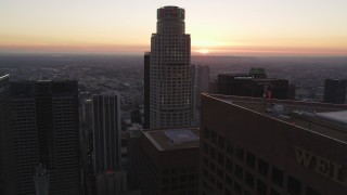 5K aerial stock footage flyby US Bank Tower in Downtown Los Angeles toward setting sun on horizon, California Aerial Stock Footage | DCLA_252