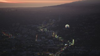 5K aerial stock footage of flying by the back of a blimp flying over the Sunset Strip at twilight, West Hollywood, California Aerial Stock Footage | DCLA_277