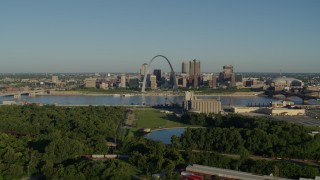 5.7K aerial stock footage of a park and St. Louis skyline seen from across Mississippi River, sunrise, Downtown St. Louis, Missouri Aerial Stock Footage | DX0001_000534