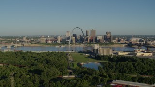 5.7K aerial stock footage of a park along the river, city skyline and Arch, sunrise, Downtown St. Louis, Missouri Aerial Stock Footage | DX0001_000543