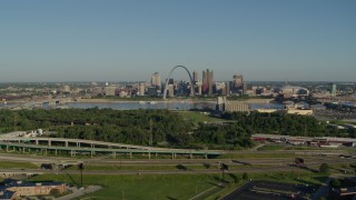 5.7K aerial stock footage of  a park and freeway with views of skyline and Arch, sunrise, Downtown St. Louis, Missouri Aerial Stock Footage | DX0001_000544