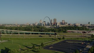 DX0001_000545 - 5.7K aerial stock footage of city skyline and Arch while descending below a freeway in East St. Louis, sunrise, Downtown St. Louis, Missouri