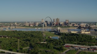 5.7K aerial stock footage reverse over freeway and park showcasing skyline and Arch, sunrise, Downtown St. Louis, Missouri Aerial Stock Footage | DX0001_000548