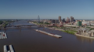 5.7K aerial stock footage of barges in the river near the Gateway Arch in Downtown St. Louis, Missouri Aerial Stock Footage | DX0001_000576