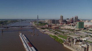 DX0001_000577 - 5.7K aerial stock footage flying over Mississippi River with barges near Downtown St. Louis, Missouri