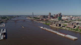 5.7K aerial stock footage of a view of riverfront buildings and barges on the river, Downtown St. Louis, Missouri Aerial Stock Footage | DX0001_000584