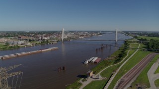 DX0001_000591 - 5.7K aerial stock footage of barges in the river and a cable-stayed bridge, St. Louis, Missouri