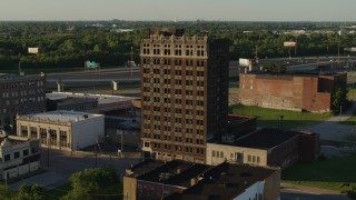 5.7K aerial stock footage of flying away from an abandoned office building at sunset, East St. Louis, Illinois Aerial Stock Footage | DX0001_000674