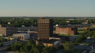 5.7K aerial stock footage approach an abandoned brick office building at sunset in East St. Louis, Illinois Aerial Stock Footage | DX0001_000675