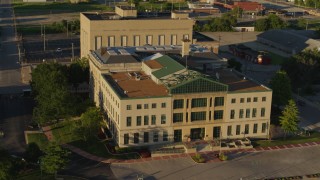 DX0001_000692 - 5.7K aerial stock footage circle and fly away from a federal courthouse at sunset, East St. Louis, Illinois