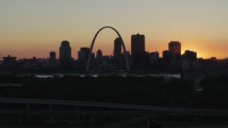 5.7K aerial stock footage ascend and approach the Gateway Arch and Downtown St. Louis, Missouri skyline in silhouette at sunset Aerial Stock Footage | DX0001_000728