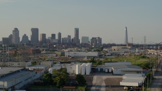 5.7K aerial stock footage ascend with view of city's skyline and Gateway Arch seen from warehouses, Downtown St. Louis, Missouri Aerial Stock Footage | DX0001_000835