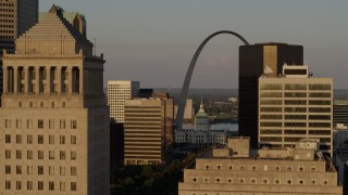 5.7K aerial stock footage flyby office buildings, reveal Gateway Arch and museum at sunset, Downtown St. Louis, Missouri Aerial Stock Footage | DX0001_000840