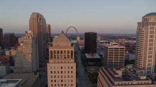 5.7K aerial stock footage of a static then reverse view of the Arch seen over a courthouse at sunset, Downtown St. Louis, Missouri Aerial Stock Footage | DX0001_000868