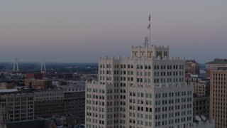 DX0001_000887 - 5.7K aerial stock footage of orbiting the top of a downtown apartment building at twilight, Downtown St. Louis, Missouri