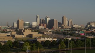 5.7K aerial stock footage descend and flyby the downtown skyline and freeway interchange at sunrise, Downtown Kansas City, Missouri Aerial Stock Footage | DX0001_001025