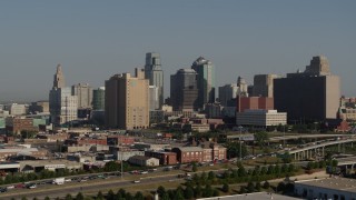 5.7K aerial stock footage slow reverse view of freeway, office building and skyscrapers in Downtown Kansas City, Missouri Aerial Stock Footage | DX0001_001056