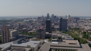 5.7K aerial stock footage of the city skyline behind Crown Center office buildings, Downtown Kansas City, Missouri Aerial Stock Footage | DX0001_001085