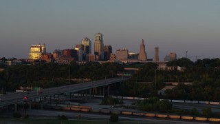 5.7K aerial stock footage of the setting sun reflecting off skyscrapers in Downtown Kansas City, Missouri Aerial Stock Footage | DX0001_001171