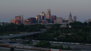 DX0001_001181 - 5.7K aerial stock footage fly over brick office building to reveal skyline at twilight in Downtown Kansas City, Missouri