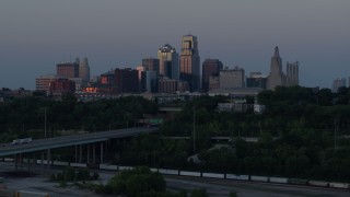 5.7K aerial stock footage of the city skyline at twilight while flying near freeway in Downtown Kansas City, Missouri Aerial Stock Footage | DX0001_001193