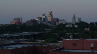 5.7K aerial stock footage of city skyline while descending by brick building at twilight, Downtown Kansas City, Missouri Aerial Stock Footage | DX0001_001197