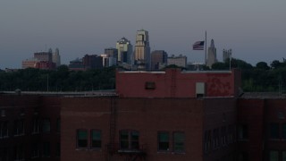 5.7K aerial stock footage ascend by brick building at twilight, reveal skyline of Downtown Kansas City, Missouri Aerial Stock Footage | DX0001_001198