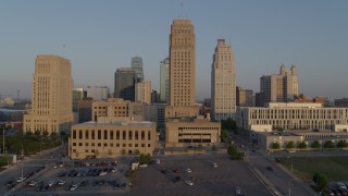 DX0001_001210 - 5.7K aerial stock footage passing city hall and skyscraper at sunrise, Downtown Kansas City, Missouri