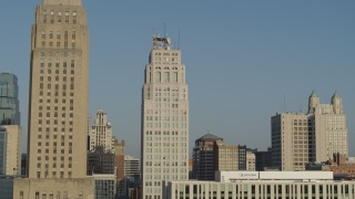 DX0001_001245 - 5.7K aerial stock footage fly by skyscraper next to city hall at sunrise, Downtown Kansas City, Missouri