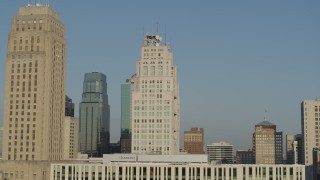 DX0001_001246 - 5.7K aerial stock footage slowly flyby skyscraper next to city hall at sunrise, Downtown Kansas City, Missouri